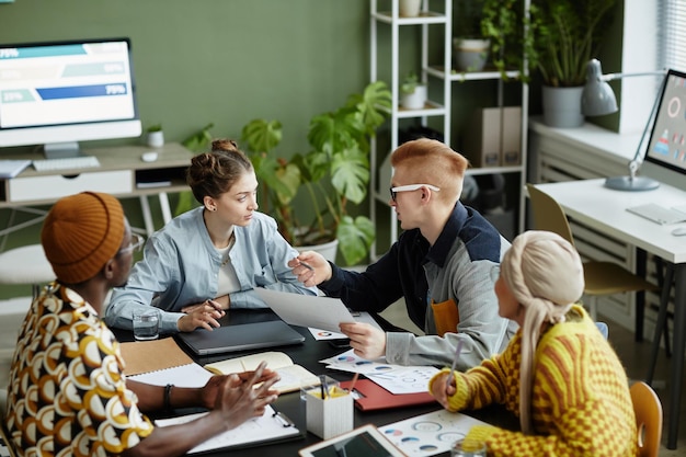 Diversas equipes criativas colaborando em reuniões de negócios e aproveitando o trabalho em projetos juntos