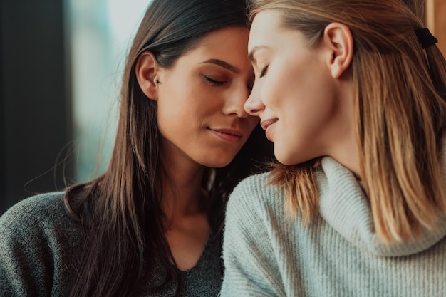 Diversas meninas casal de lésbicas abraçando. Feche o retrato. As mulheres elegantes da geração z que namoram no amor desfrutam de relacionamentos românticos. Conceito LGBTQ.