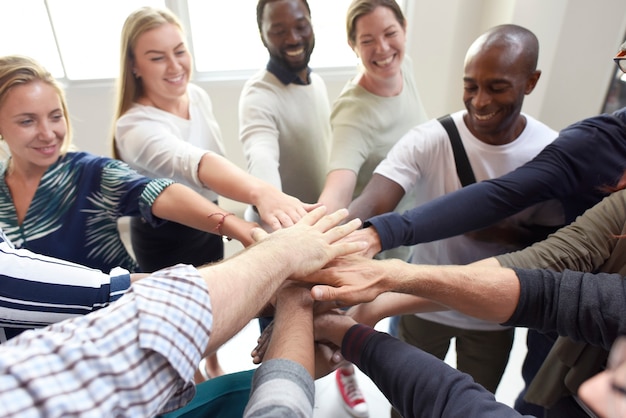 Diversidad de trabajo en equipo con manos unidas.