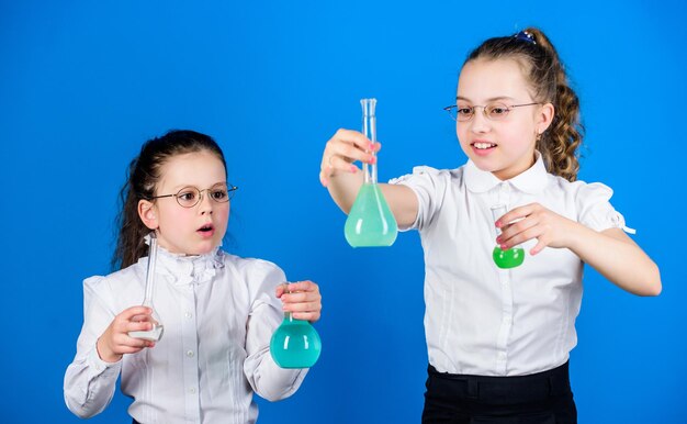 Diversión química Conocimientos básicos Día del conocimiento Colegiala con líquidos químicos Concepto de educación Medidas de seguridad Conocimiento e información Experimentar un poco Estudio de niños pequeños Concepto de educación