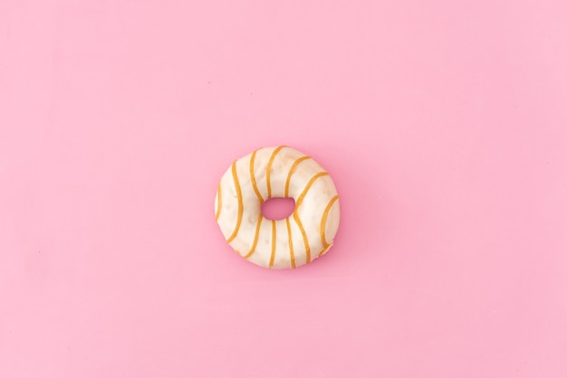 Diversos buñuelos adornados en el movimiento que cae en fondo rosado. Dulces y coloridos donuts cayendo o volando en movimiento.