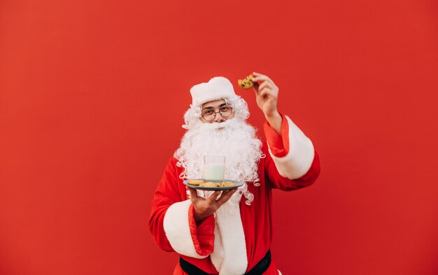 Divertido Papá Noel con galletas y un vaso de leche