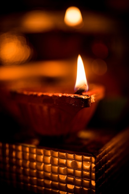 Diwali Diya oder Beleuchtung in der Nacht mit Geschenken, Blumen über einer stimmungsvollen Szene