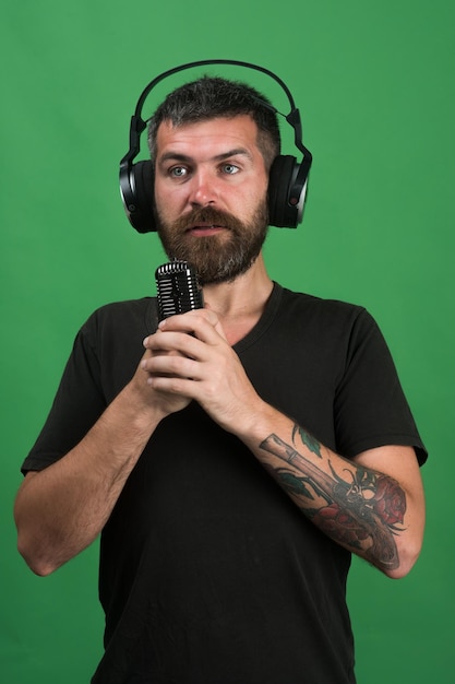 Dj com barba usa fones de ouvido tecnologias e conceito de música