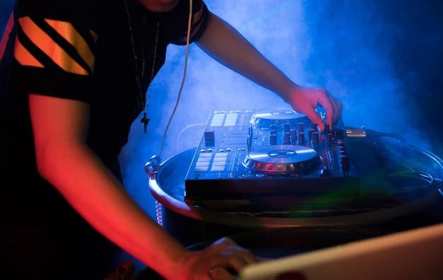 Foto dj tocando música giradiscos en la fiesta del club nocturno