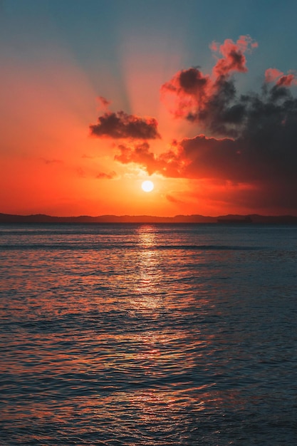 por do sol rosado em meio ao mar com nuvens