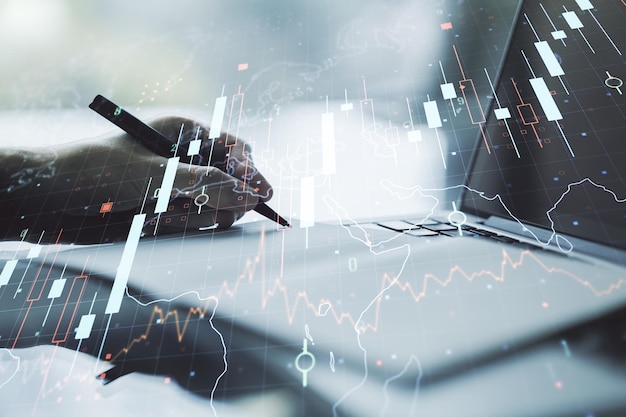 Doble exposición de diagrama financiero creativo abstracto con mapa mundial y con escritura a mano en el bloc de notas en segundo plano con concepto de computadora portátil, banca y contabilidad