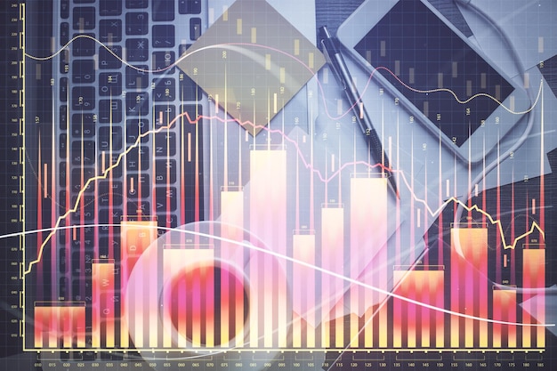 Doble exposición del dibujo del gráfico financiero sobre el fondo de la tabla con computadora Concepto de investigación y análisis Vista superior