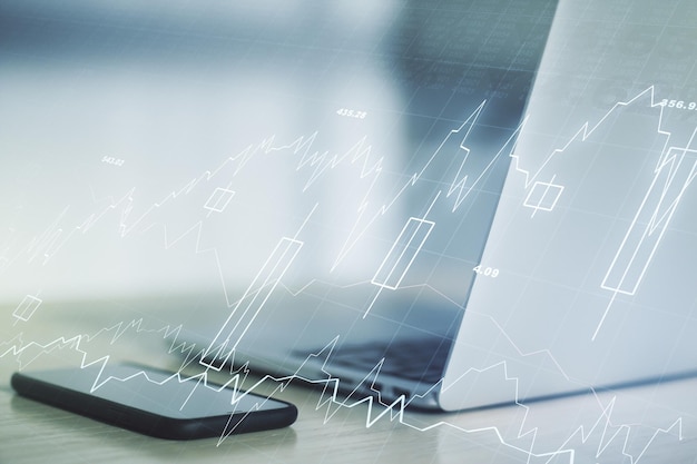 Doble exposición del gráfico financiero creativo abstracto sobre el concepto de estrategia e investigación de antecedentes de portátiles modernos