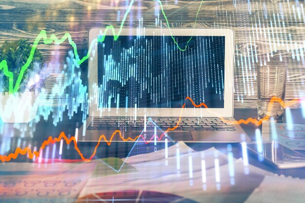 Doble exposición de gráficos e información financiera y espacio de trabajo con antecedentes informáticos Concepto de comercio internacional en línea