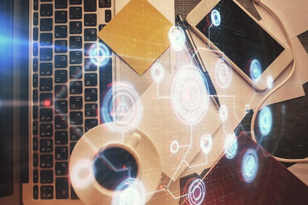 Doble exposición del holograma de dibujo de datos sobre la vista superior del fondo del escritorio de estudio con computadora Concepto de Ai