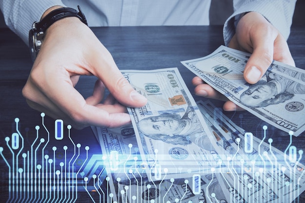 Doble exposición de holograma de dibujo de tecnología y billetes de dólares estadounidenses y manos de hombre Concepto de datos