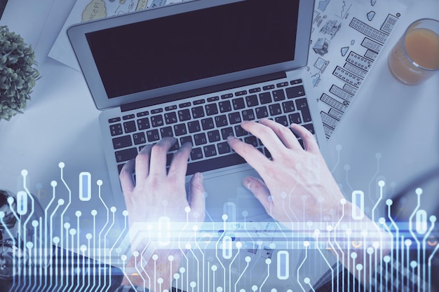 Doble exposición de las manos del hombre escribiendo sobre el teclado de la computadora y dibujo de hologramas de datos Vista superior Concepto tecnológico