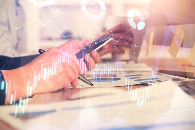 Doble exposición de las manos del hombre sosteniendo y usando un teléfono y dibujando gráficos financieros Concepto de análisis de mercado