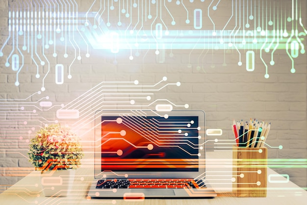 Doble exposición de la mesa con la computadora en el fondo y el concepto de tecnología de datos del holograma del tema de los datos