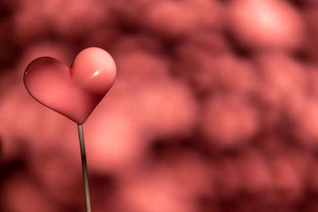 Doce de pirulito em forma de coração rosa dia dos namorados em fundo de papel pastel vazio conceito de amor