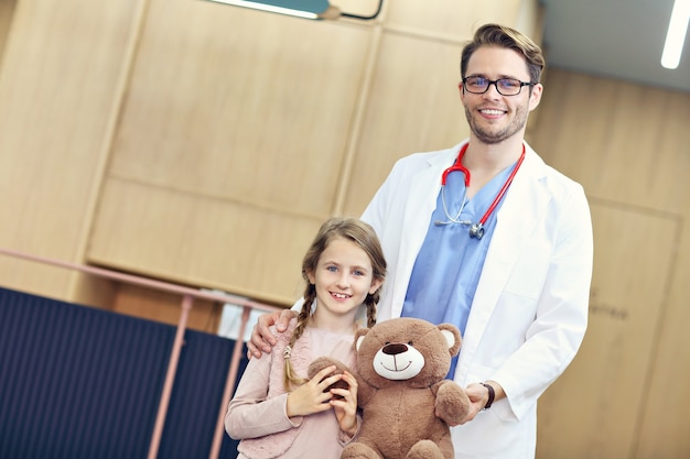 doctor dando la bienvenida a la niña en la clínica