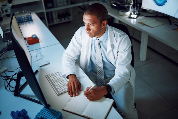 Doctor escribiendo y noche con computadora en laboratorio para investigación médica y estudio con atención médica Papeleo profesional masculino y planificación con datos para biotecnología en clínica u hospital