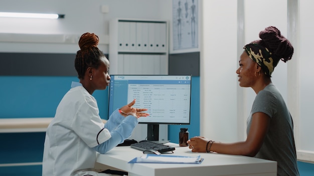 Doctor hablando con el paciente sobre el dolor físico y la enfermedad.