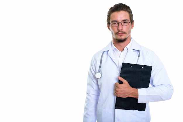 Doctor hermoso joven del hombre que sostiene el tablero aislado