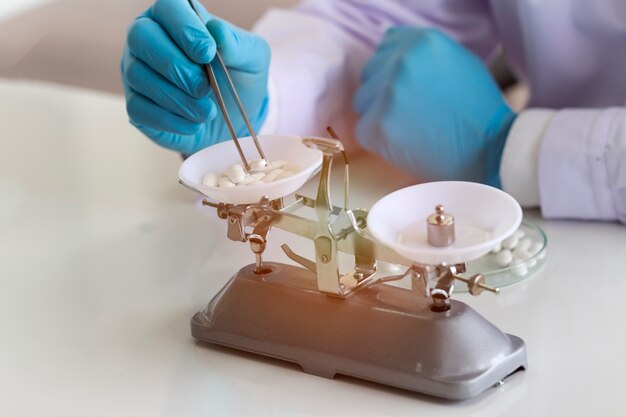 Foto el doctor en medicina está pesando los medicamentos por balanza de cosecha en el laboratorio