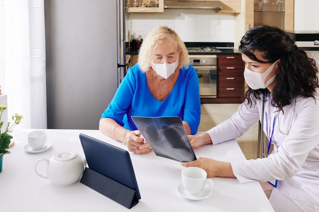 Doctor mostrando radiografía de pulmones al paciente