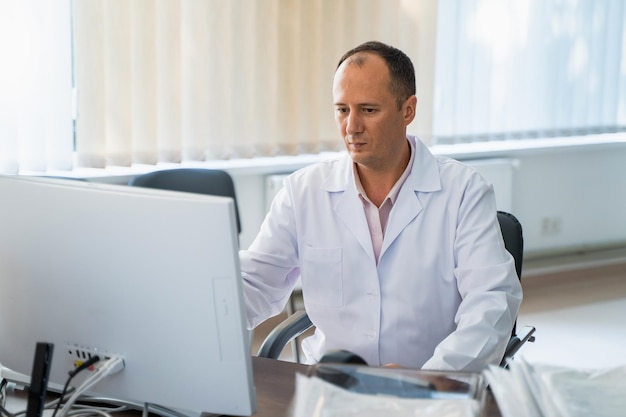 Doctor trabajando con la computadora en la oficina