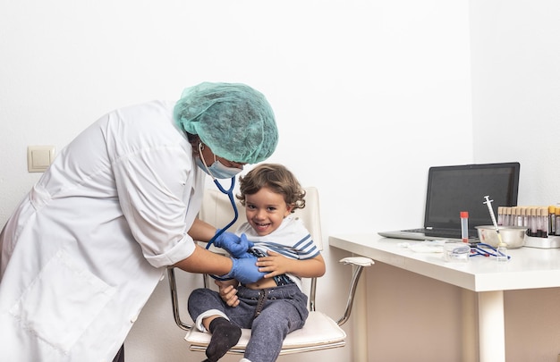 Doctora examinando a un niño pequeño.