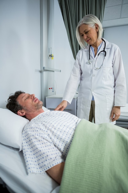 Doctora examinando a un paciente en sala