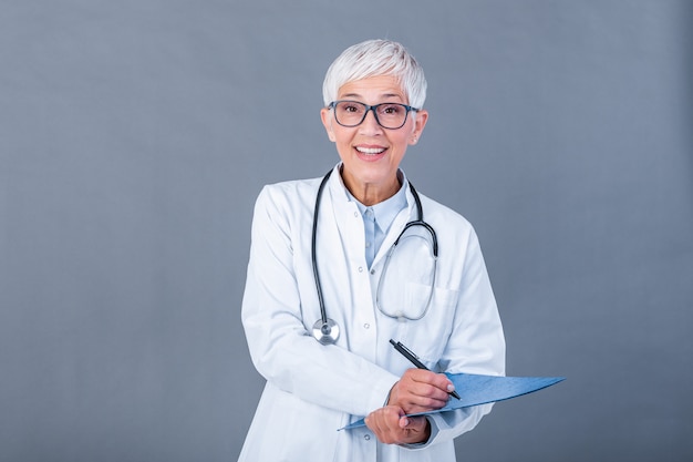 Doctora madura escribiendo en portapapeles