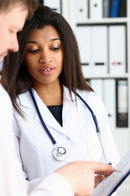 Doctora mano sostenga la pluma de plata y mostrando