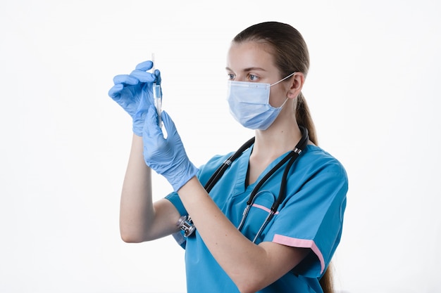 Doctora con medicina en mano sobre un fondo blanco.