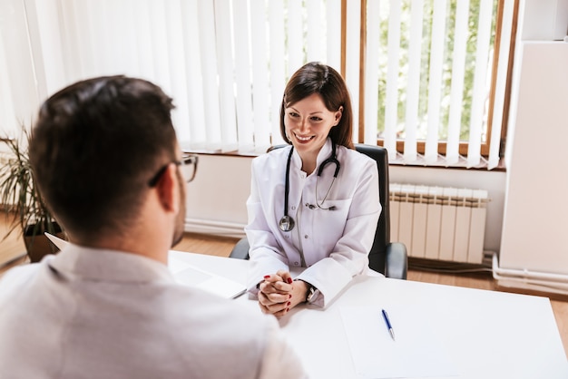 Doctora sonriente hablando con el paciente