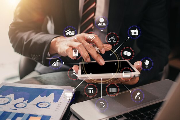 Documentos de negocios en la mesa de la oficina con portátil y tableta digital y gráfico financiero