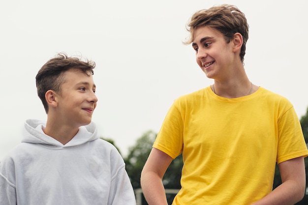 Foto dois adolescentes jovens felizes em pé conversando