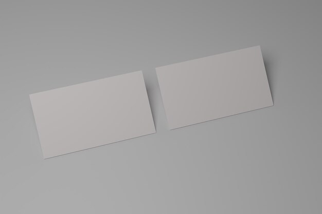 Dois cartões de visita brancos em um fundo cinza