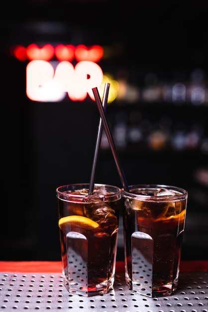 Dois copos com uísque e coquetel de cola em um bar de boate Vida noturna Boa porção de coquetéis