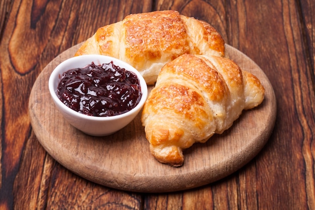 Dois deliciosos croissants em uma tábua de madeira