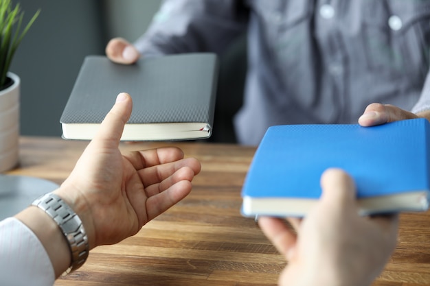 Dois empresários trocando com notebooks no local de trabalho de escritório