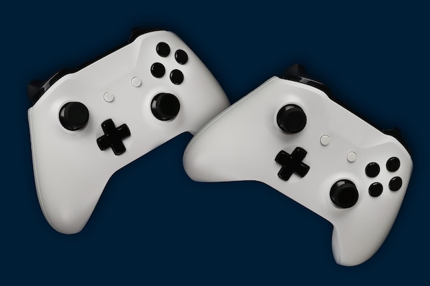 Foto dois gamepads em voo em um fundo azul escuro