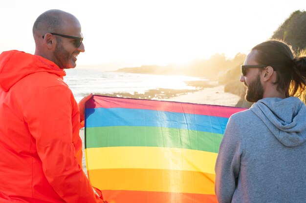 Foto dois gays seguram bandeira lgbt