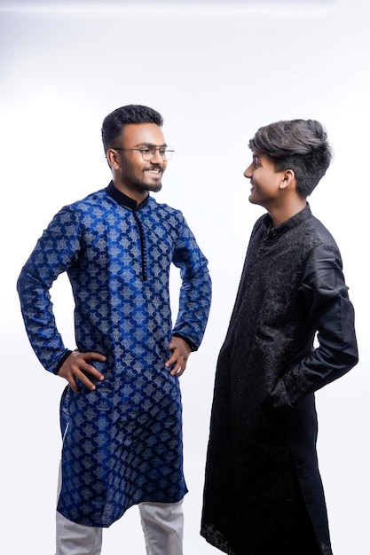 Dois homens indianos usam panos étnicos ou tradicionais Modelos de moda masculina com sherwani ou Kurta Pijama em pé e posando sobre foco seletivo de fundo branco