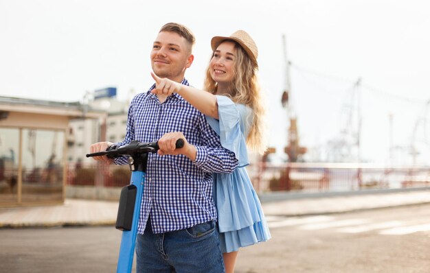 Dois jovens viajam de scooter elétrico na cidade. Passar tempo juntos, conceito de amor