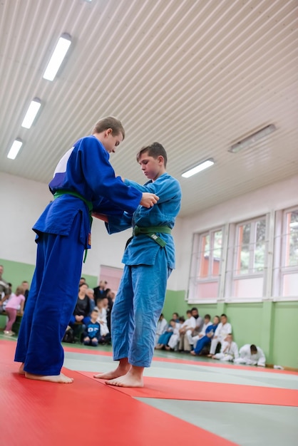 Dois lutadores de judô mostrando habilidade técnica enquanto praticam artes marciais em um clube de luta Os dois homens aptos em uniforme lutam karatê treinamento artes atleta competição conceito Foco seletivo