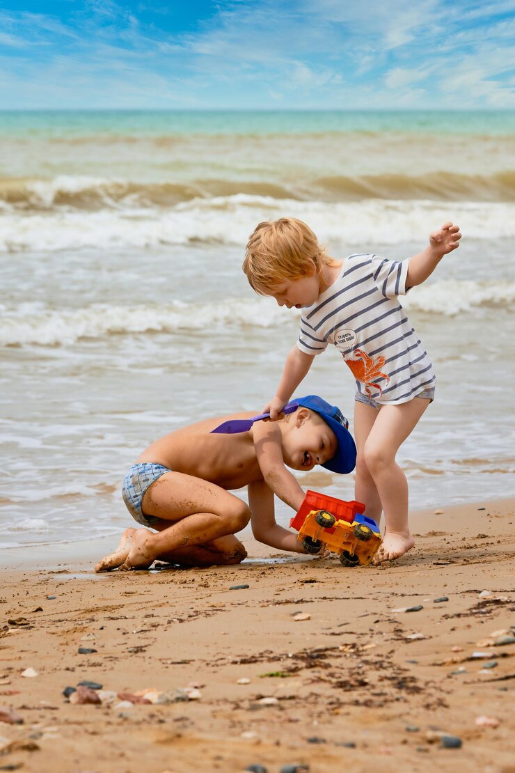 Foto dois meninos brincando na praia
