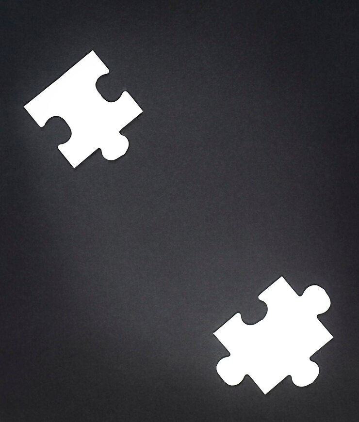 Foto dois quebra-cabeças brancos em um fundo preto