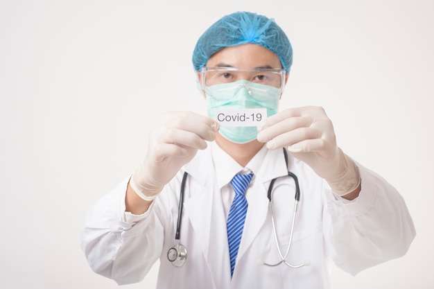 Doktor hält Covid-19-Karte auf weißem Hintergrund