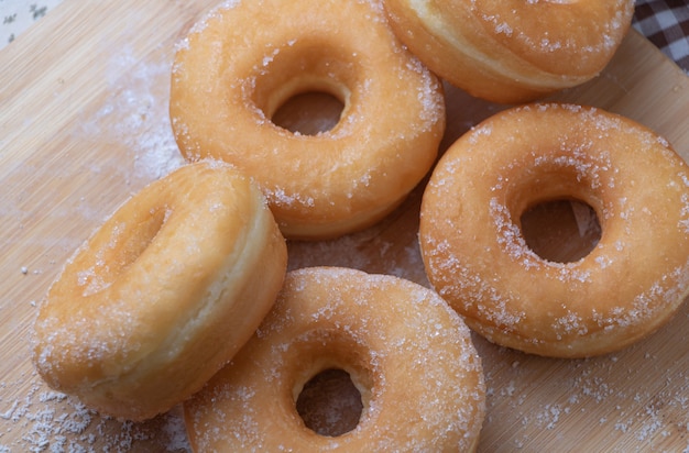 Donas de azúcar en tablero de madera