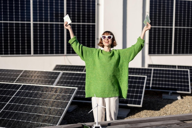 Dono de família feliz com dinheiro perto de usina de energia solar