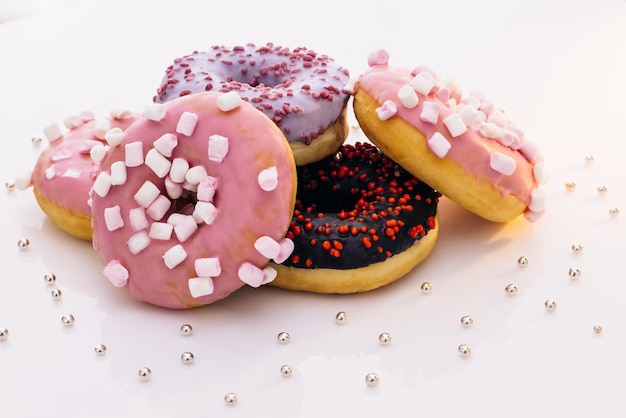 Donuts de arte conceitual de fundo branco Donuts de diferentes cores sobremesas doces vitrificadas fast food ba